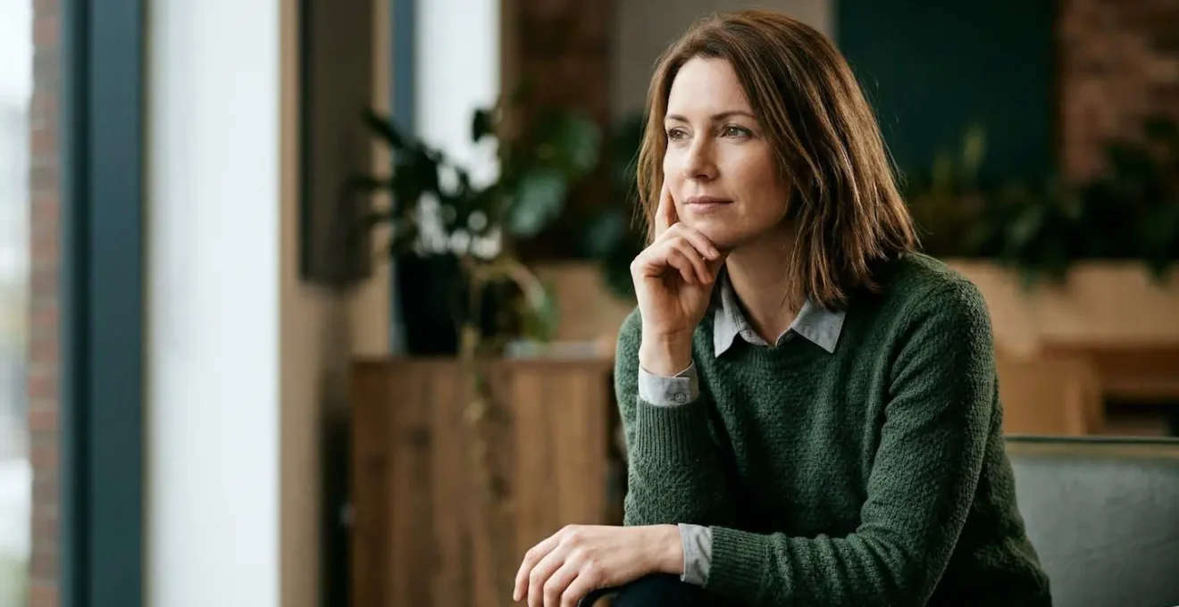 Professional contemplating health insurance value proposition with natural lighting